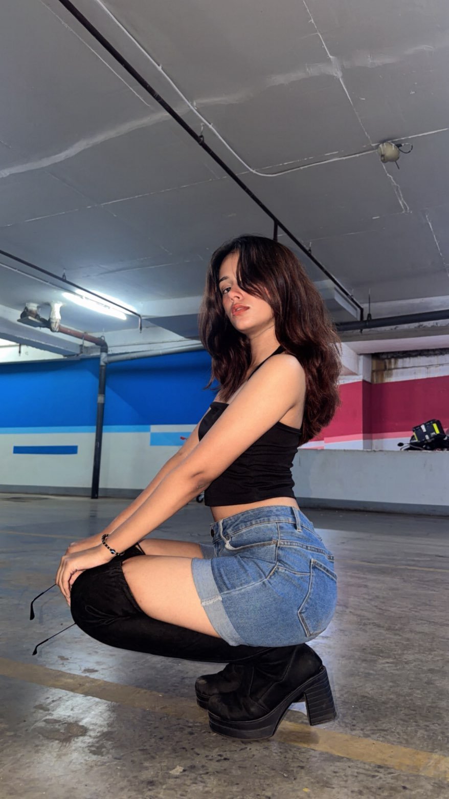 Janvi Saxena in denim and a black top, seated on a staircase